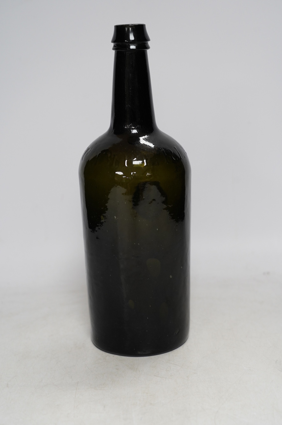 A George IV sealed wine bottle, DBD 1827, moulded script around shoulder, Imperial Patent, 29cm. Condition - commensurate with age